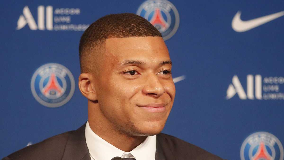 PSG striker Kylian Mbappe smiles during a press conference Monday, May 23, 2022 at the Paris des Princes stadium in Paris. Kylian Mbappé's decision to reject Real Madrid and commit to Paris Saint-Germain for three more seasons marks the start of a large rebuilding project at the French league champion. (AP Photo/Michel Spingler)