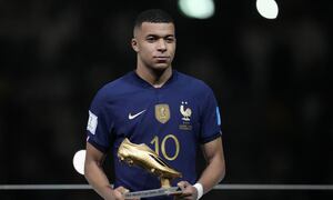 France's Kylian Mbappe holds the Golden Boot award for top goalscorer of the tournament after the World Cup final soccer match between Argentina and France at the Lusail Stadium in Lusail, Qatar, Sunday, Dec. 18, 2022. Argentina won 4-2 in a penalty shootout after the match ended tied 3-3. (AP Photo/Martin Meissner)