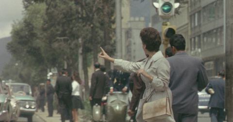 Una mujer en Bogotá en los 60's parando un taxi.