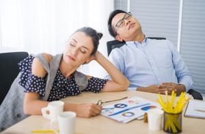 Coffee break time Business and team sleeping at  in conference room during meeting office desk. Young businessman with eyeglasses overworked and fell asleep Creative casual man sleeping at his working place
