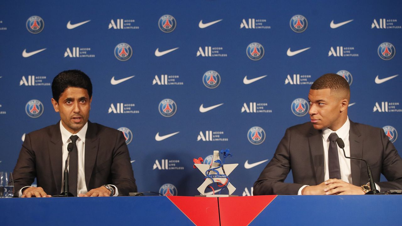 PSG striker Kylian Mbappe, right, and PSG president Nasser Al-Al-Khelaifi attend a press conference Monday, May 23, 2022 at the Paris des Princes stadium in Paris. Kylian Mbappé's decision to reject Real Madrid and commit to Paris Saint-Germain for three more seasons marks the start of a large rebuilding project at the French league champion. (AP Photo/Michel Spingler)
