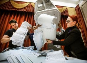 Members of a local electoral commission empty a ballot box at a polling station after the last day of the three-day parliamentary election, in Moscow, on September 19, 2021. - The vote will see lawmakers elected to the 450-member lower house State Duma, where United Russia currently holds 334 seats, and to several local legislatures. After a year that saw a historic crackdown on the opposition and with President Vladimir Putin's United Russia party floundering in the polls, authorities are doing what they can to drum up interest in parliamentary elections taking place over three days from 17-19 September, 2021. (Photo by Alexander NEMENOV / AFP)
