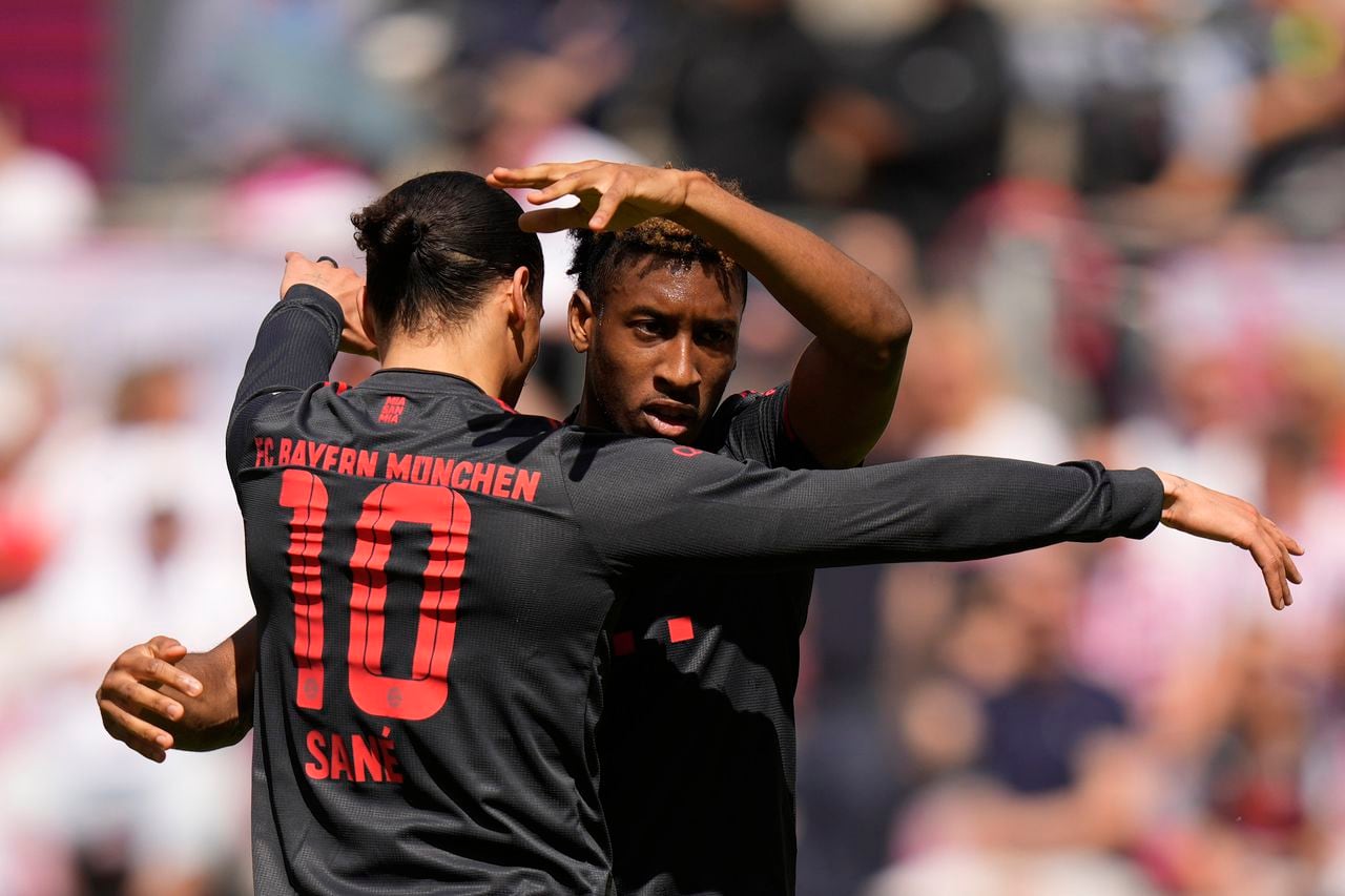 Bayern's Kingsley Coman, right, celebrates after scoring his side's opening goal besides team mate Leroy Sane during the German Bundesliga soccer match between 1. FC Cologne and FC Bayern Munich in Cologne, Germany, Saturday, May 27, 2023. (AP Photo/Matthias Schrader)