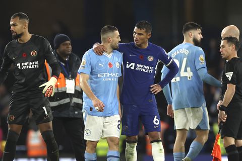 Chelsea's Thiago Silva leaves the field with Manchester City's Mateo Kovacic at the end of the English Premier League soccer match between Chelsea and Manchester City at Stamford Bridge stadium in London, Sunday, Nov. 12, 2023. (AP Photo/Ian Walton)