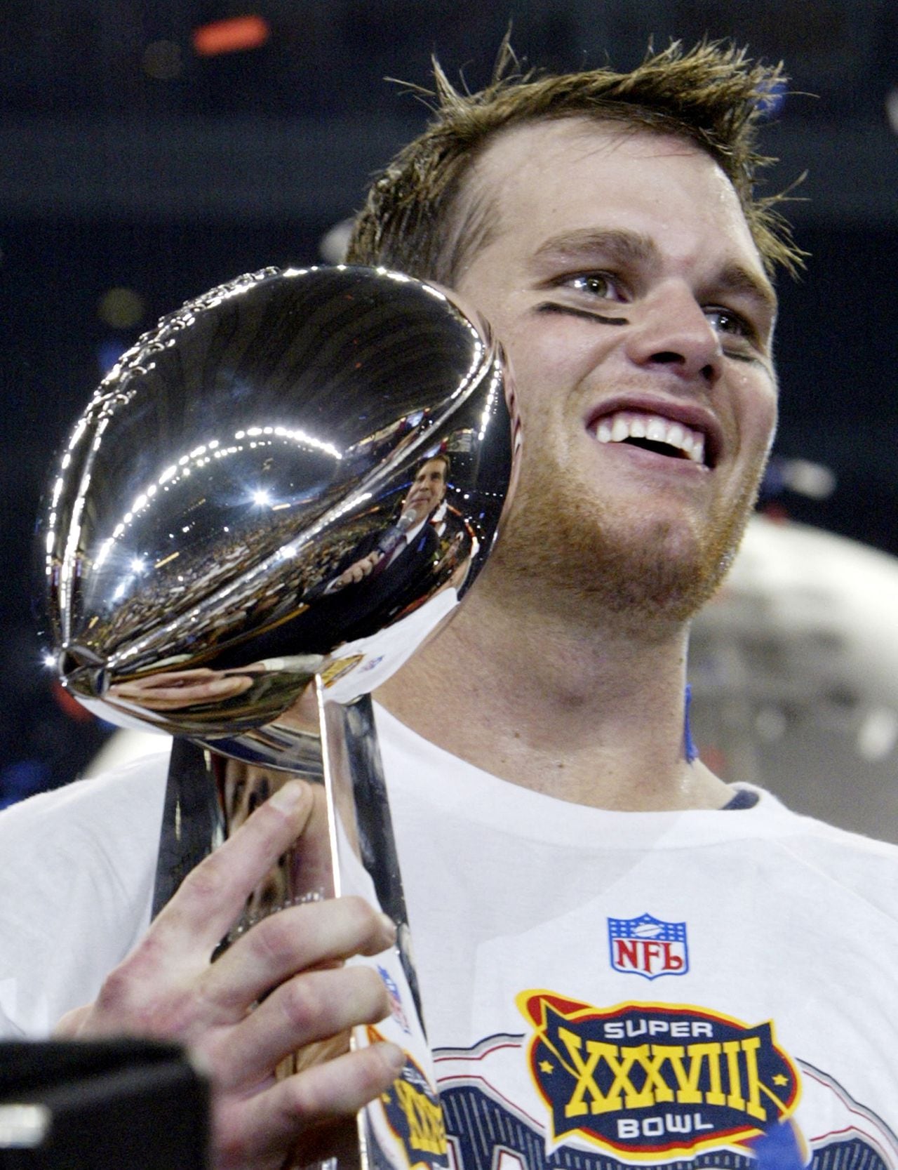 (FILES) In this file photo taken on JFebruary 1, 2004, Quarterback Tom Brady of the New England Patriots holds the Vince Lombardi trophy after winning Super Bowl XXXVIII, at Reliant Stadium in Houston, Texas. - Brady announced his retirement on February 1, 2023, at the age of 45 after a storied career that included a record-breaking seventh Super Bowl victory in 2021 and a temporary retirement last year. "I'll get to the point right away: I'm retiring, for good," Brady said in a social media video. (Photo by JEFF HAYNES / AFP)