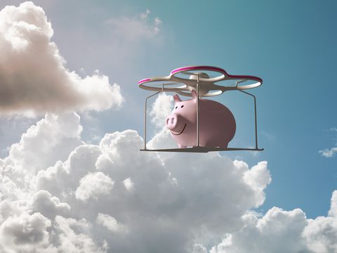 Piggy bank flying in the sky on a drone