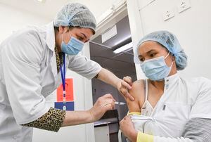 FILE - A medical worker administers a shot of China's Sinovac vaccine to a patient in Bishkek, Kyrgyzstan, Monday, March 29, 2021. (AP Photo/Vladimir Voronin, File)