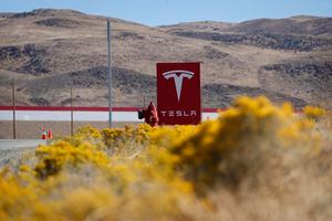 FILE - In this Oct. 13, 2018 file photo, a sign marks the entrance to the Tesla Gigafactory in Sparks, Nev. Tesla CEO Elon Musk solved a mystery involving a 27-year-old Russian who prosecutors say flew to the United States to offer a major-company insider $1 million to assist in a ransomware extortion attack on the firm. According to the billionaire, the scheme took aim at the electric car company’s 1.9 million-square-foot factory in Sparks, Nevada, which makes batteries for Tesla vehicles and energy storage units. (AP Photo/John Locher, File)