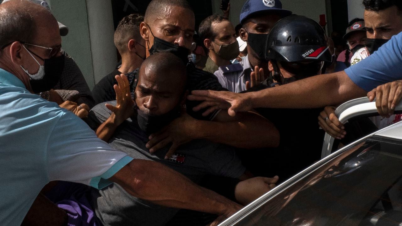 Police detain an anti-government demonstrator during a protest in Havana, Cuba, Sunday July 11, 2021. Hundreds of demonstrators went out to the streets in several cities in Cuba to protest against ongoing food shortages and high prices of foodstuffs, amid the new coronavirus crisis. (AP Photo/Ramon Espinosa)