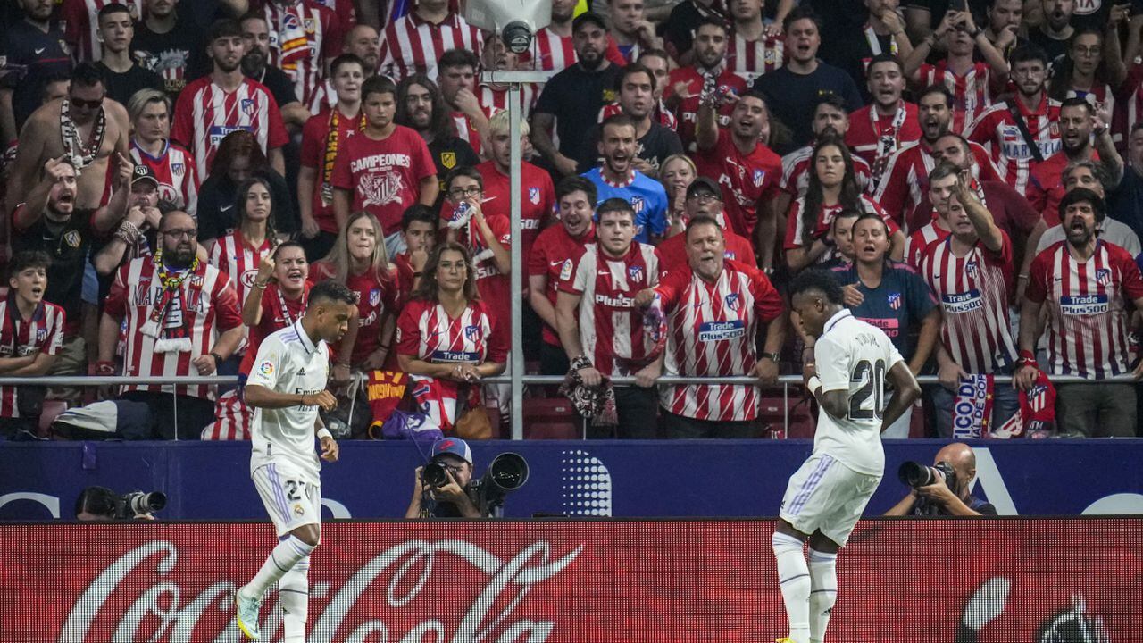 FILE - Real Madrid's Rodrygo, left, celebrates after scoring with his teammate Real Madrid's Vinicius Junior the opening goal during the Spanish La Liga soccer match between Atletico Madrid and Real Madrid at the Wanda Metropolitano stadium in Madrid, Spain, Sept. 18, 2022. With a goal and a dance, Real Madrid's young Brazilian forwards made a strong statement against racism in soccer this weekend. With their samba-like moves after a goal in the derby against Atletico on Sunday, Rodrygo and Vinícius Junior made it clear they are not backing down. (AP/Manu Fernandez)