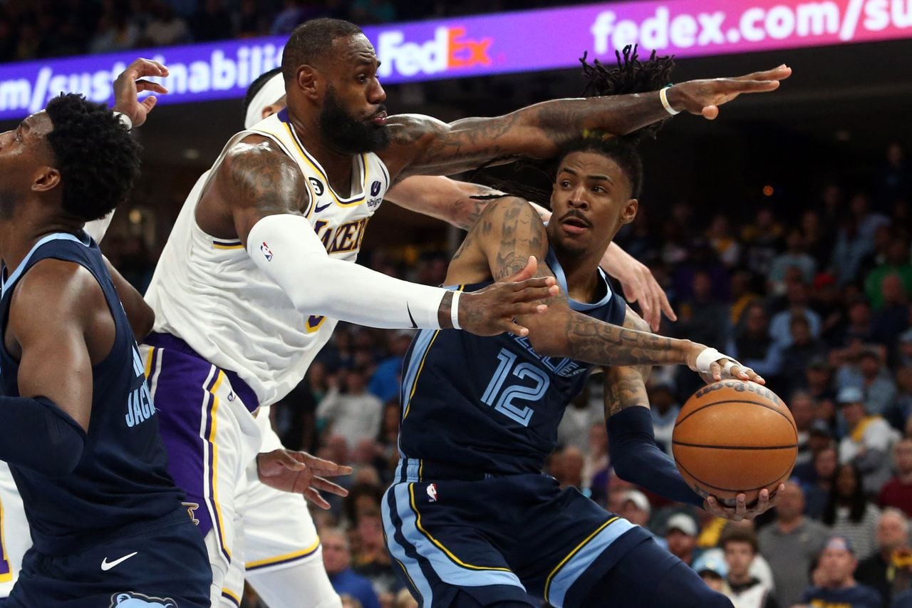 Apr 16, 2023; Memphis, Tennessee, USA; Memphis Grizzlies guard Ja Morant (12) passes the ball as Los Angeles Lakers forward LeBron James (6) defends during the second half during game one of the 2023 NBA playoffs at FedExForum. Mandatory Credit: Petre Thomas-USA TODAY Sports
