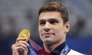 FILE - Evgeny Rylov of the Russian Olympic Committee poses with his gold medal for the men's 100-meter backstroke final at the 2020 Summer Olympics, Tuesday, July 27, 2021, in Tokyo, Japan. A statement from swimming's world governing body, FINA, on Thursday, April 21, 2022, announced that Rylov has been banned from the sport for nine months for appearing at a rally in support of President Vladimir Putin and Russia’s invasion of Ukraine. (AP Photo/Matthias Schrader, File)