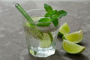 Glass of water with chia seeds  and lime on a gray  background. A healthy drink for weight loss.