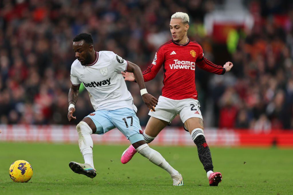 MANCHESTER, ENGLAND - FEBRUARY 4: Maxwel Cornet of West Ham United and Antony of Manchester United during the Premier League match between Manchester United and West Ham United at Old Trafford on February 4, 2024 in Manchester, England. (Photo by James Baylis - AMA/Getty Images)
