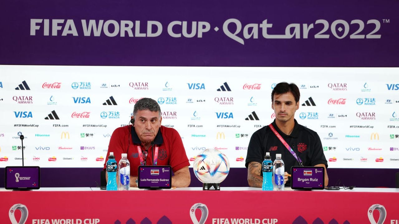 DOHA, QATAR - NOVEMBER 22: Luis Fernando Suarez, Head Coach of Costa Rica, and Bryan Ruiz (R) of Costa Rica speak during the Costa Rica Press Conference at Main Media Center on November 22, 2022 in Doha, Qatar. (Photo by Mohamed Farag/Getty Images)