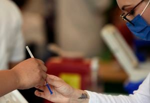 A nurse prepares a dose of the Pfizer-BioNTech vaccine against COVID-19 at the vaccination center set up at the Campo Marte, Mexico City on April 12, 2021. (Photo by ALFREDO ESTRELLA / AFP)