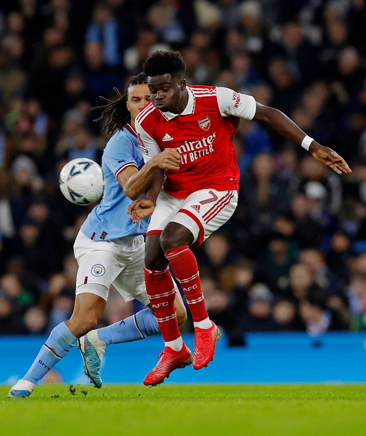 Soccer Football - FA Cup - Fourth Round - Manchester City v Arsenal - Etihad Stadium, Manchester, Britain - January 27, 2023 Arsenal's Bukayo Saka in action with Manchester City's Nathan Ake Action Images via Reuters/Jason Cairnduff