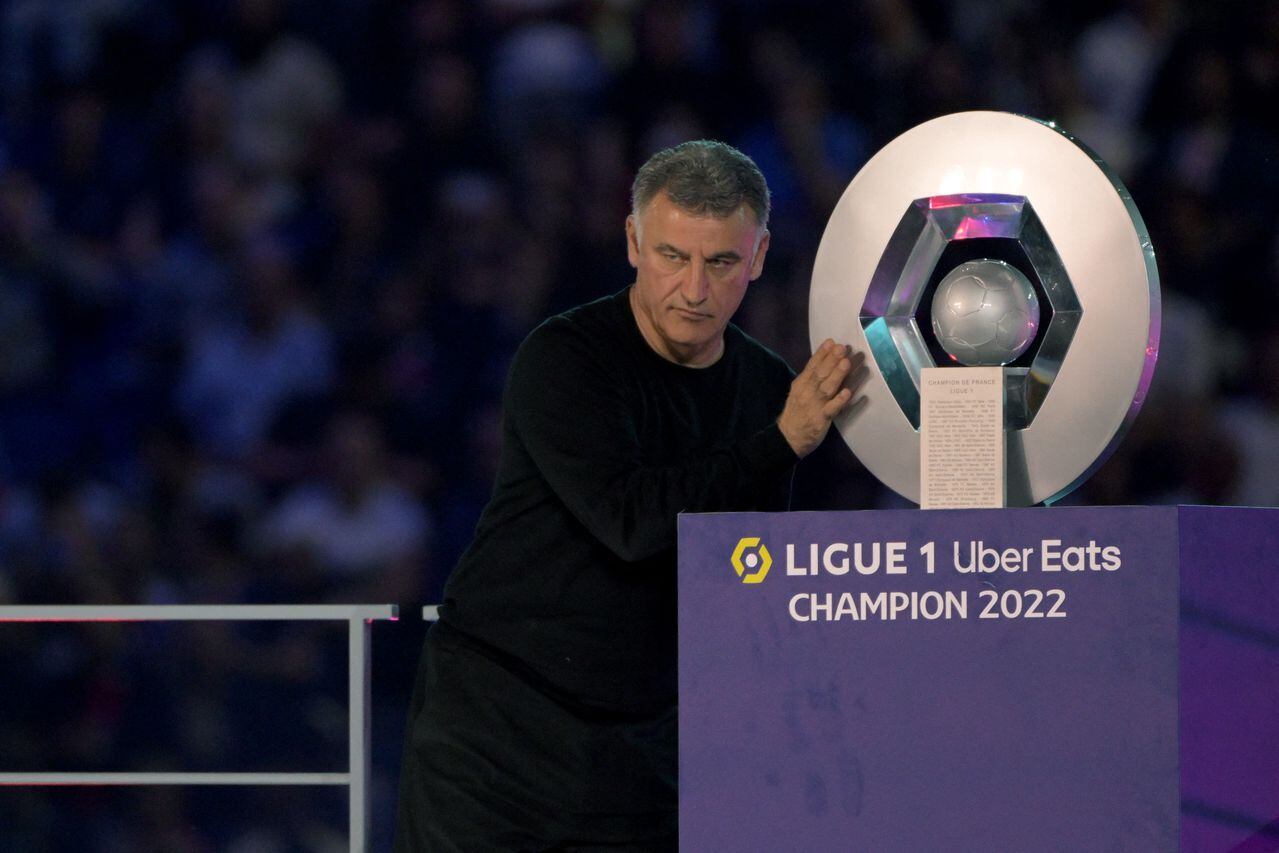 Paris Saint-Germain's French head coach Christophe Galtier poses with the trophy after Paris Saint-Germain's French L1 championship during the 2022-2023 Ligue1 trophy ceremony following the L1 football match between Paris Saint-Germain (PSG) and Clermont Foot 63 at the Parc des Princes Stadium in Paris on June 3, 2023. (Photo by Alain JOCARD / AFP)