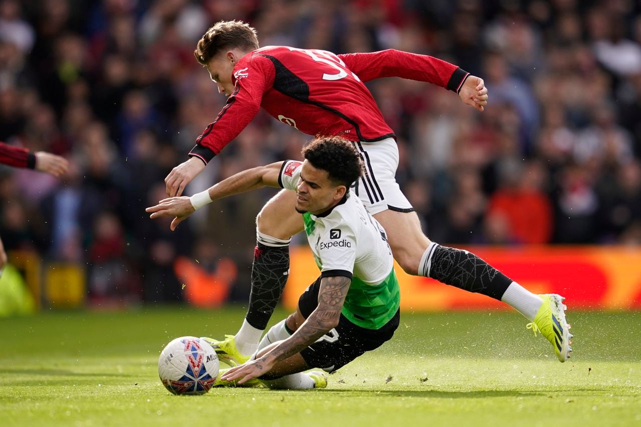 Liverpool's Luis Diaz is fouled by Manchester United's Scott McTominay, rear, during the FA Cup quarterfinal soccer match between Manchester United and Liverpool at the Old Trafford stadium in Manchester, England, Sunday, March 17, 2024. (AP Photo/Dave Thompson)