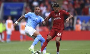 Liverpool's Luis Diaz, right, fights for the ball with Manchester City's Kyle Walker during the FA Community Shield soccer match between Liverpool and Manchester City at the King Power Stadium in Leicester, England, Saturday, July 30, 2022. (AP Photo/Leila Coker)