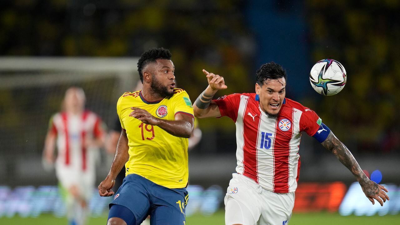 Colombia's Miguel Angel Borja, left, fights for the ball with Paraguay's Gustavo Gomez during a qualifying soccer match for the FIFA World Cup Qatar 2022, at Metropolitano stadium in Barranquilla, Colombia, Tuesday, Nov. 16, 2021. (AP Photo/Fernando Vergara)