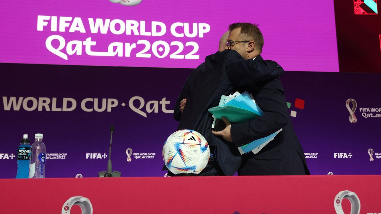 Soccer Football - FIFA World Cup Qatar 2022 - FIFA President Press Conference - Main Media Center, Doha, Qatar - November 19, 2022 FIFA president Gianni Infantino embraces FIFA Director of Media Relations Bryan Swanson after he made an announcement during a press conference REUTERS/Matthew Childs