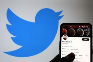 NEWCASTLE-UNDER-LYME, ENGLAND - NOVEMBER 21: The Twitter account of Elon Musk is displayed on a smartphone with a Twitter logo in the background on November 21, 2022 in Newcastle Under Lyme, England. (Photo by Nathan Stirk/Getty Images)