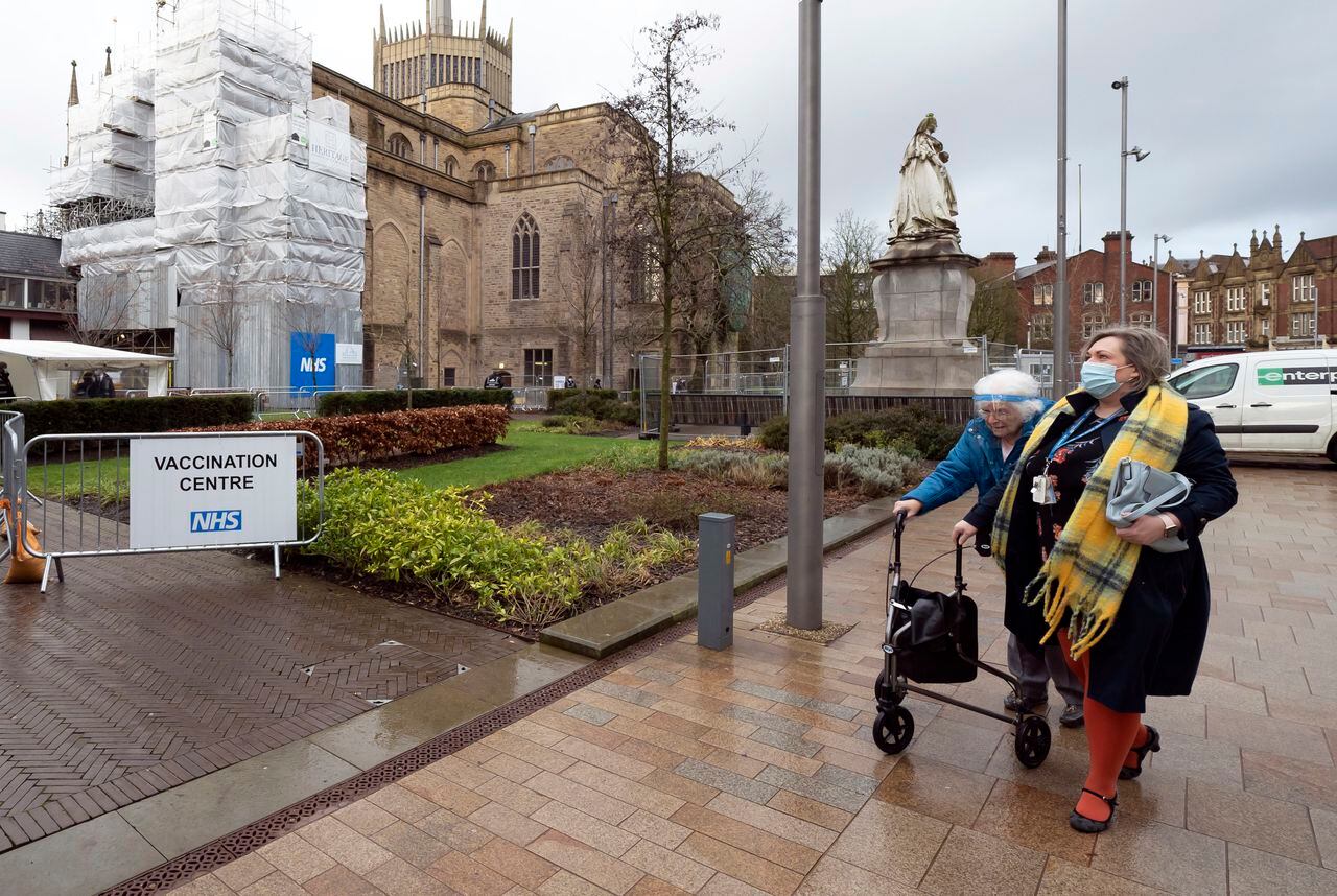 Members of the public arrive at Blackburn Cathedral, which is being used as a mass vaccination center during the coronavirus outbreak in Blackburn, England, Monday Jan. 18, 2021. The first 24-hour vaccination centers will be piloted in London before the end of January, the UK's vaccines minister Nadhim Zahawi has said. ( AP Photo Jon Super)