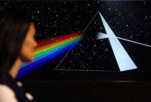 ATTENTION: EMBARGOED FOR PUBLICATION UNTIL 14 SEPTEMBER 14:30 GMT!  - 13 September 2018, North Rhine-Westphalia, Dortmund: 13 September 2018, Germany, Dortmund: A woman stands in the so-called "Dortmunder U" in the exhibition The Pink Floyd Exhibition and looks at an animated projection of the prism from the flap cover of the album "The Dark Side of the Moon". The exhibition, conceived in London with members of the band, will only be shown in Dortmund within the German-speaking region. Photo: Bernd Thissen/dpa (Photo by Bernd Thissen/picture alliance via Getty Images)