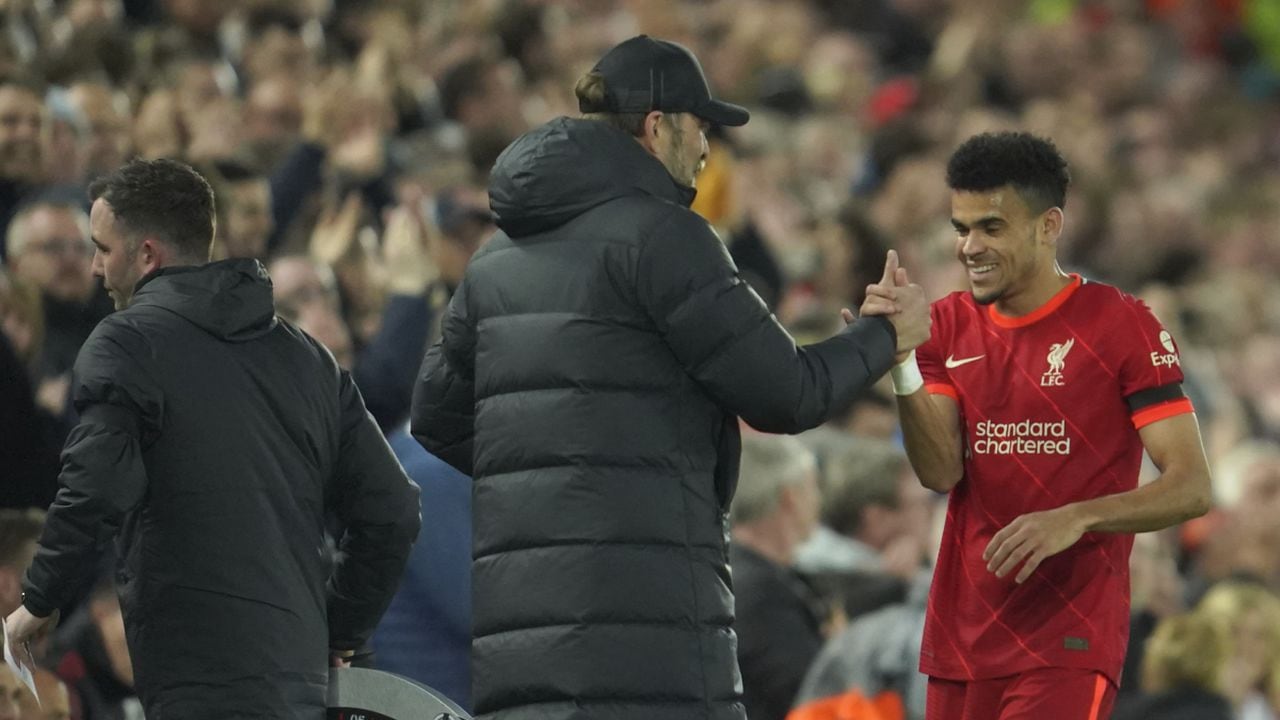 Liverpool's Luis Diaz, right, is congratulated by his manager Jurgen Klopp during the English Premier League soccer match between Liverpool and Manchester United at Anfield stadium in Liverpool, England, Tuesday, April 19, 2022. (AP/Jon Super)