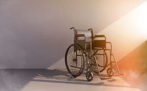 black wheelchair in beam of light. 3d rendering