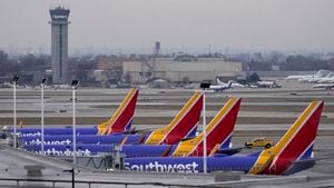 Four Southwest Airlines passenger jets sit at their gates at Chicago's Midway Airport as flight delays stemming from a computer outage at the Federal Aviation Administration has brought departures to a standstill across the U.S. Wednesday, Jan. 11, 2023, in Chicago. (AP Photo/Charles Rex Arbogast)