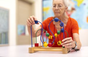 Old Woman make exercise why she is protected Alzheimer's disease