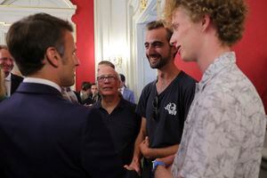 French President Emmanuel Macron meets Henri, second right, the 24-year-old 'backpack hero', his friend Lilian and Youssouf, who suffered minor stab wounds as he tried to intercept the suspect as he fled, in Annecy, French Alps, Friday, June 9, 2023. A man with a knife stabbed four young children at a lakeside park in the French Alps on Thursday June 8, 2023, assaulting at least one in a stroller repeatedly. Authorities said the children, between 22 months and 3 years old, suffered life-threatening injuries, and two adults were also wounded. (Denis Balibouse/Pool via AP)
