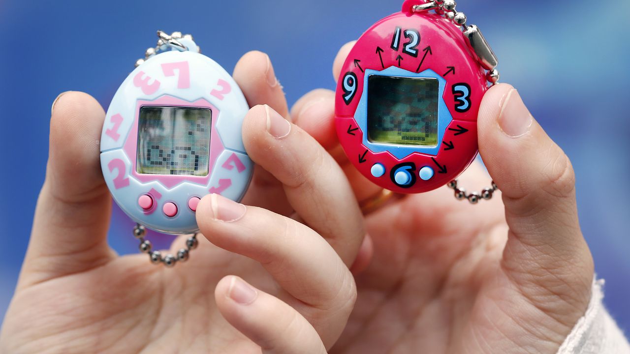 PARIS, FRANCE - OCTOBER 25:  Children show their "Tamagotchi" electronic pet on October 25, 2017 in Paris, France. Tamagotchi is a virtual electronic animal which means "cute little egg" and simulates the life of an animal. Twenty years after its creation, the Japanese company Bandai reissues the famous limited edition toy that is available today in France. Tamagotchi will be available in the United States on November 5, 2017.  (Photo by Chesnot/Getty Images)