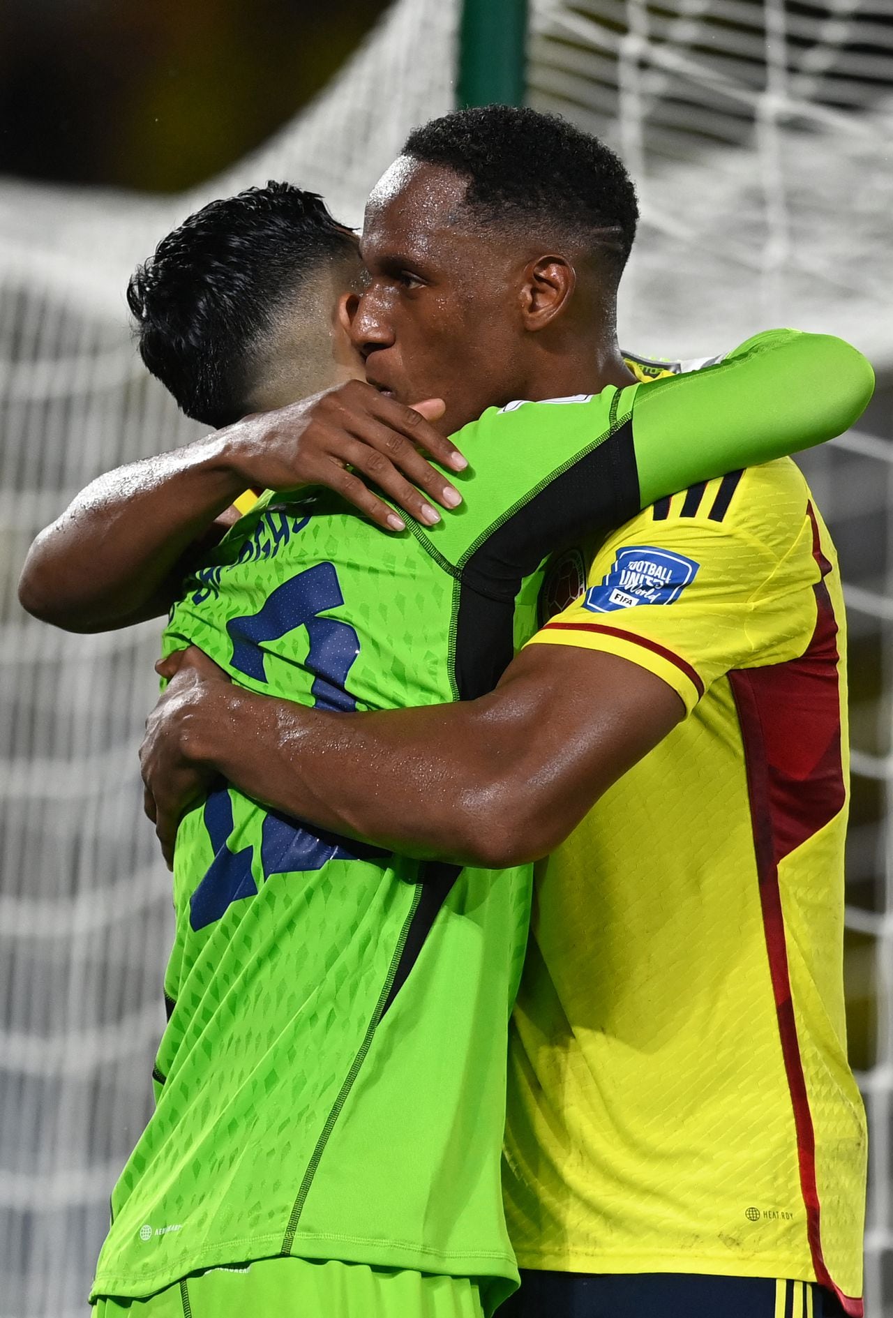 Colombia's goalkeeper Camilo Vargas (L) and defender Yerry Mina celebrate defeating Venezuela at the end of the 2026 FIFA World Cup South American qualifiers football match between Colombia and Venezuela at the Roberto Melendez Metropolitan stadium in Barranquilla, Colombia, on September 7, 2023. (Photo by JUAN BARRETO / AFP)