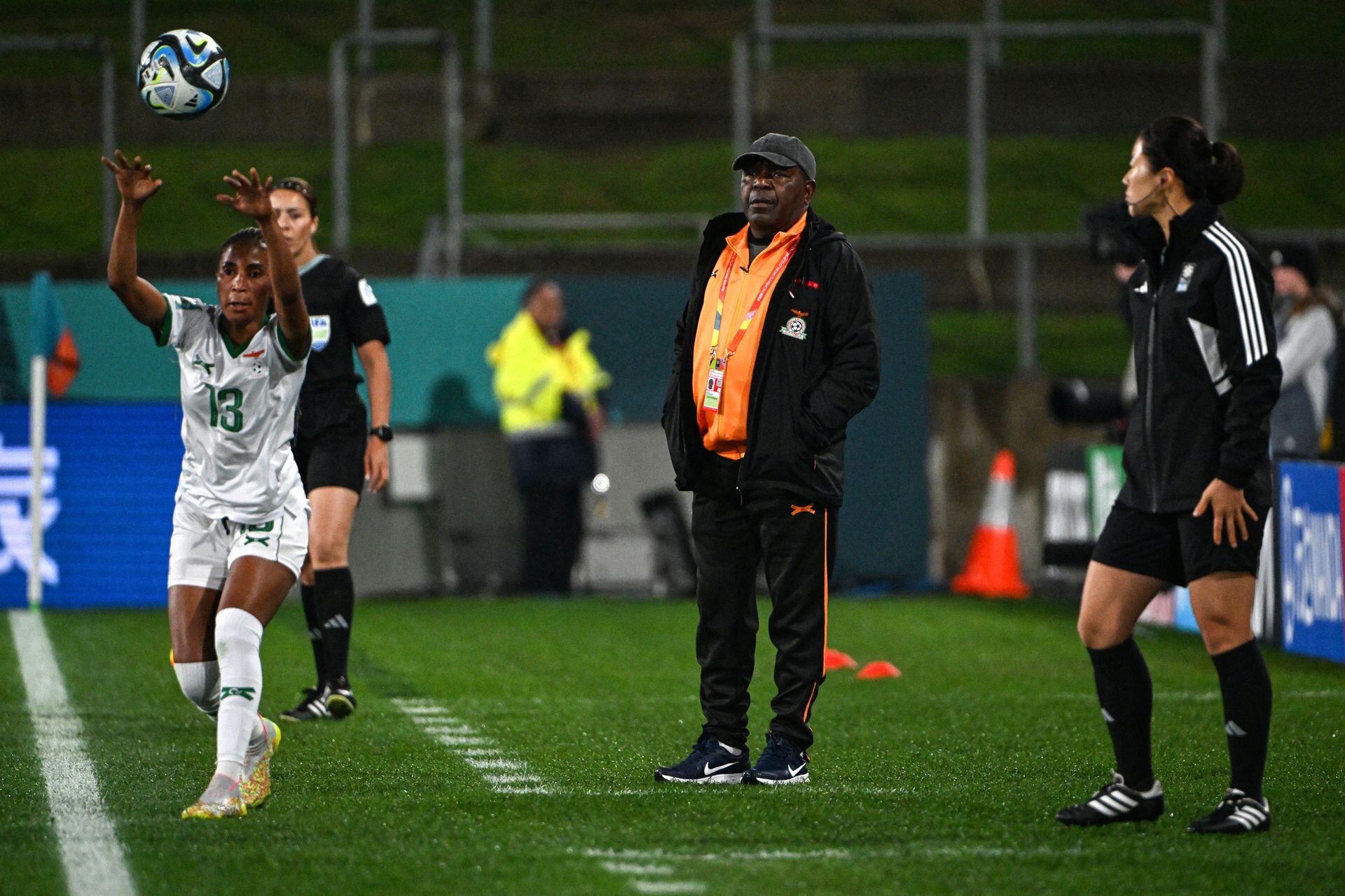 Zambia's coach Bruce Mwape (C) looks on as Zambia's defender #13 Martha Tembo (L) plays a ball during the Australia and New Zealand 2023 Women's World Cup Group C football match between Costa Rica and Zambia at Waikato Stadium in Hamilton on July 31, 2023. (Photo by Saeed KHAN / AFP)