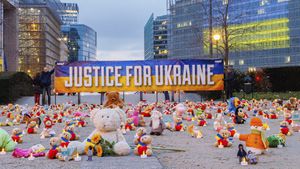 IMAGE DISTRIBUTED FOR AVAAZ.ORG - Avaaz members and Ukrainian refugees install thousands of kids' teddy bears and toys at Schuman Roundabout in front of the European Commission to highlight the reported abduction of thousands of Ukrainian children by Russia on Thursday Feb,23, 2022 in Brussels. Attendants call on EU, US, UK and Canadian leaders to sanction 14 Russian officials who are among those allegedly responsible for the abductions. (Olivier Matthys/AP Images for Avaaz.org)