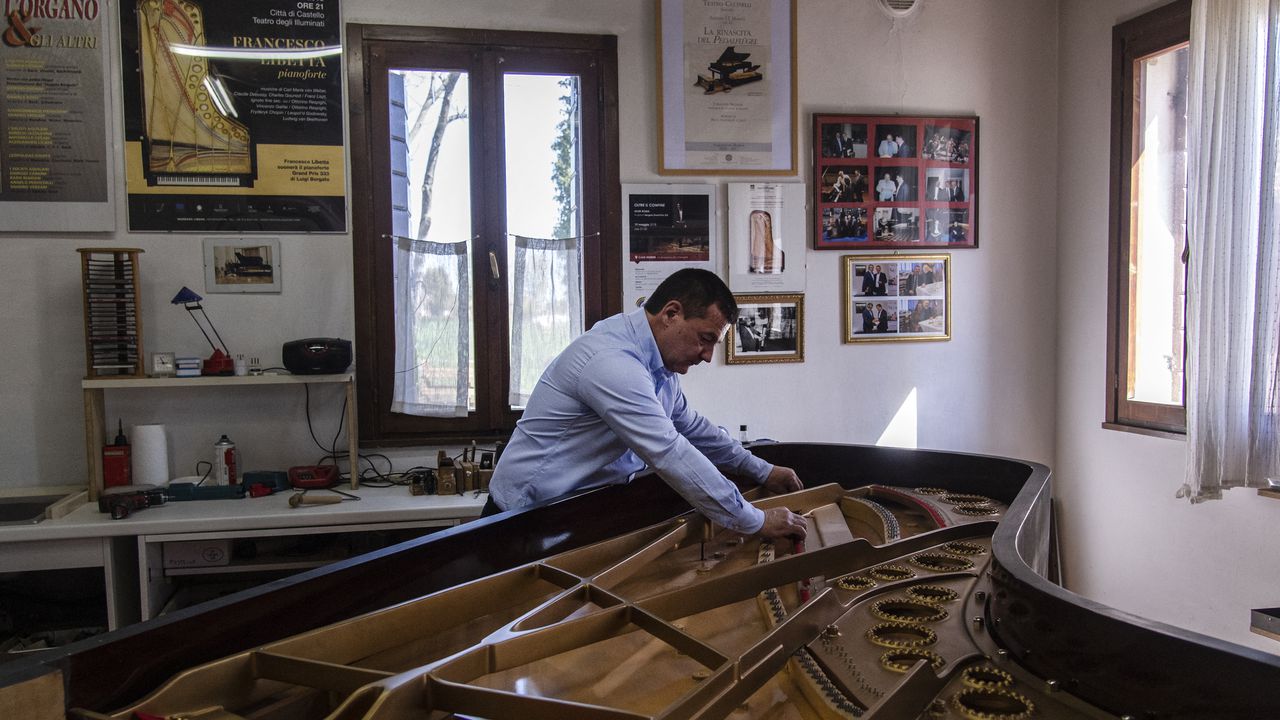 Italian piano craftsman Luigi Borgato works in his workshop in Borgo Veneto, near Padua on April 8, 2021. - Italian craftsman Luigi Borgato grew his business into a prestigious brand capable of attracting buyers from all over the world, until the coronavirus pandemic abruptly put a halt to it all. (Photo by MARCO BERTORELLO / AFP)