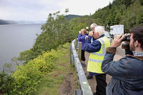 Los voluntarios observan la superficie del lago Ness en las Tierras Altas de Escocia el 27 de agosto de 2023, en busca de señales del legendario monstruo Nessie. Dos grupos emprendieron la mayor búsqueda de Nessie en 50 años el 26 y 27 de agosto, con alrededor de 100 voluntarios participando cada día.