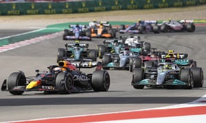 Red Bull driver Max Verstappen, of the Netherlands, front left, leads Mercedes driver Lewis Hamilton, of Britain, right, and the rest of the field during the Formula One U.S. Grand Prix auto race at the Circuit of the Americas, Sunday, Oct. 23, 2022, in Austin, Texas. (AP Photo/Charlie Neibergall)