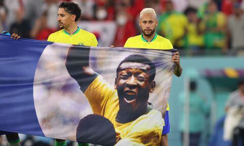 DOHA, QATAR - DECEMBER 05 Brazil's Neymar and Marquinhos hold a banner in support of former Brazil player Pele after the FIFA World Cup Qatar 2022 Round of 16 match between Brazil and South Korea at Stadium 974 on December 5, 2022 in Doha, Qatar. (Photo by Getty Images/Marc Atkins)