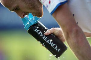 Close up of a player spitting out water from a Powerade bottle (Photo by AMA/Corbis via Getty Images)