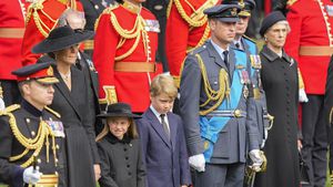 Prince William, from right, Prince George, Princess Charlotte and Kate, Princess of Wales watch as the coffin of Queen Elizabeth II is placed into the hearse following the state funeral service in Westminster Abbey in central London Monday Sept. 19, 2022. The Queen, who died aged 96 on Sept. 8, will be buried at Windsor alongside her late husband, Prince Philip, who died last year. (AP Photo/Martin Meissner, Pool)