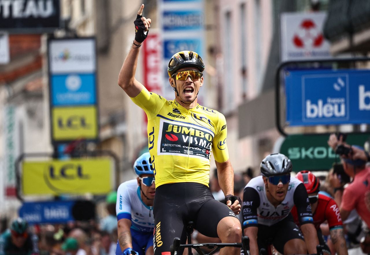 Yellow jersey of Overall Leader Jumbo-Visma's French rider Christophe Laporte (C) celebrates as he crosses the finish line to win the third stage of the 75th edition of the Criterium du Dauphine cycling race, 194,5 kms between Monistrol-Sur-Loire and Le Coteau, central-eastern France, on June 6, 2023. (Photo by Anne-Christine POUJOULAT / AFP)