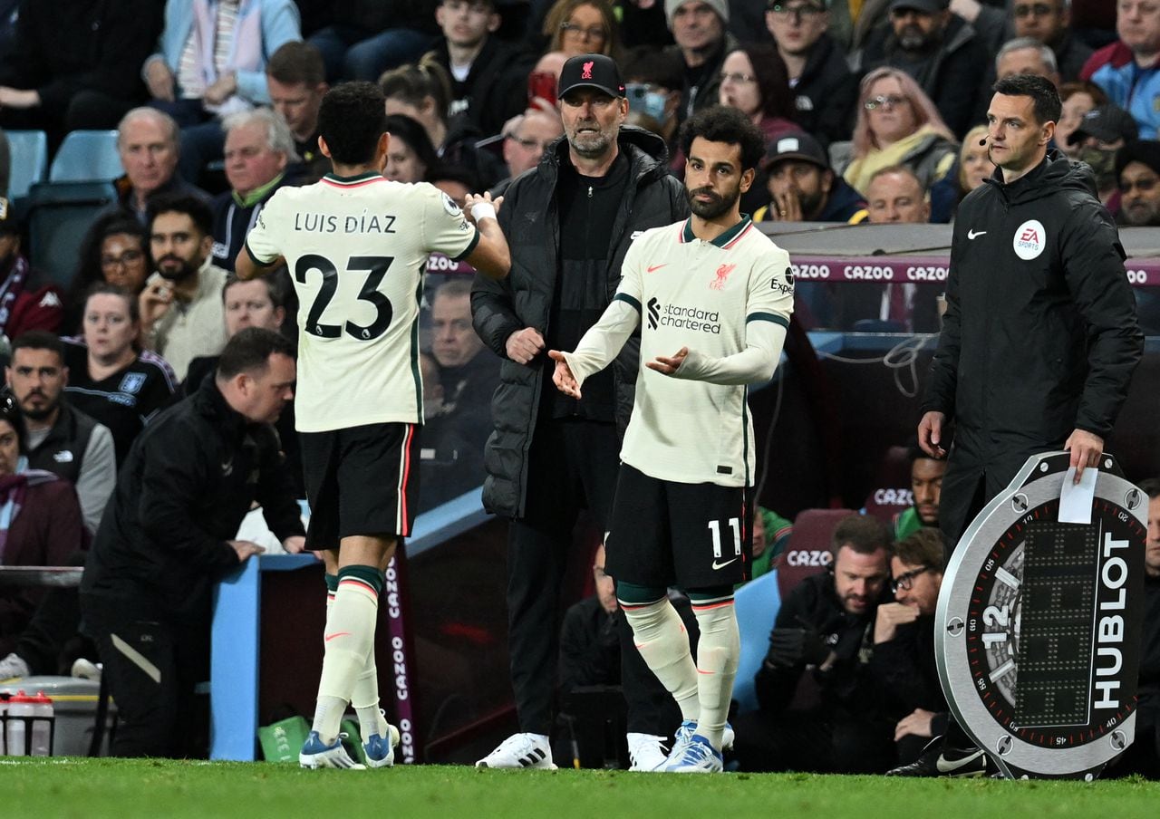Liverpool's Colombian midfielder Luis Diaz (L) leaves the pitch after being substituted off for Liverpool's Egyptian midfielder Mohamed Salah (R) during the English Premier League football match between Aston Villa and Liverpool at Villa Park in Birmingham, central England on May 10, 2022. (Photo by Paul ELLIS / AFP) / RESTRICTED TO EDITORIAL USE. No use with unauthorized audio, video, data, fixture lists, club/league logos or 'live' services. Online in-match use limited to 120 images. An additional 40 images may be used in extra time. No video emulation. Social media in-match use limited to 120 images. An additional 40 images may be used in extra time. No use in betting publications, games or single club/league/player publications. /