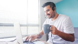 Portrait of a happy Latin American man working online at home using his laptop and smiling â telework concepts