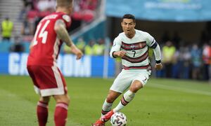 Portugal's Cristiano Ronaldo controls the ball during the Euro 2020 soccer championship group F match between Hungary and Portugal at the Ferenc Puskas stadium in Budapest, Hungary Monday, June 15, 2021. (AP Photo/Darko Bandic, Pool)
