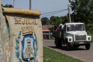 A truck passes by a sign at the entrance of Bejucal, Cuba, June 12, 2023. REUTERS/Dave Sherwood