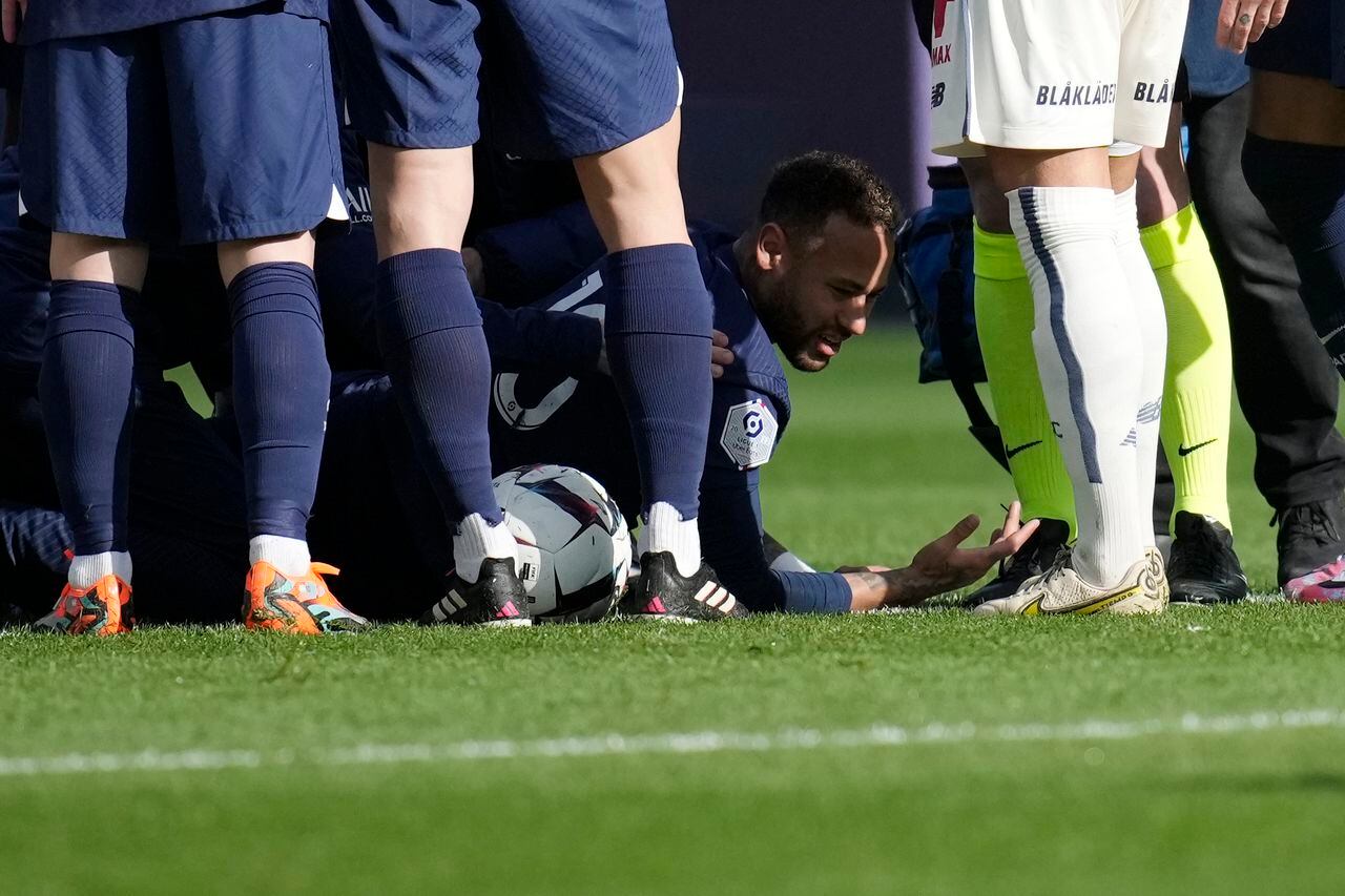 PSG's Neymar lies on the field after injuring during the French League One soccer match between Paris Saint-Germain and Lille at the Parc des Princes stadium, in Paris, France, Sunday, Feb. 19, 2023. (AP Photo/Christophe Ena)